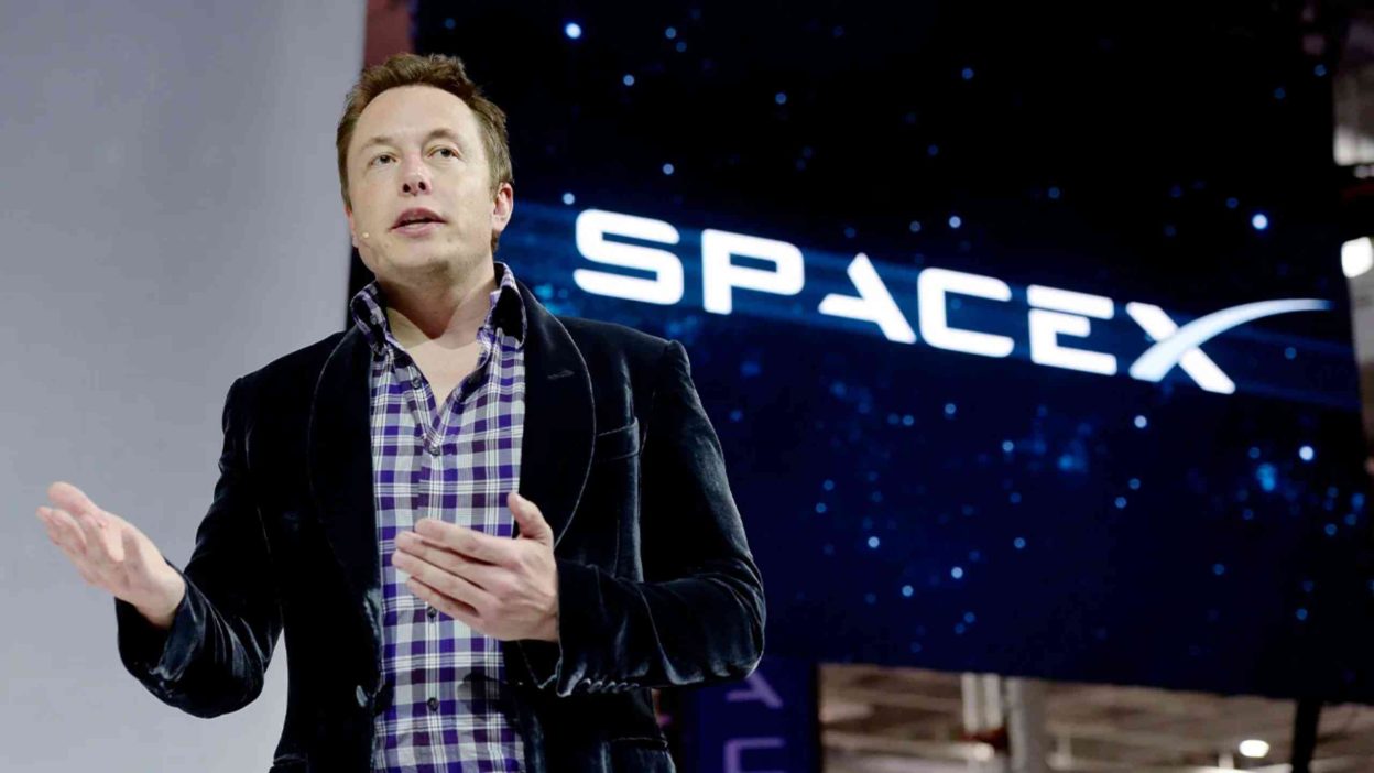 Elon Musk pictured with SpaceX logo following merger announcement with xAI