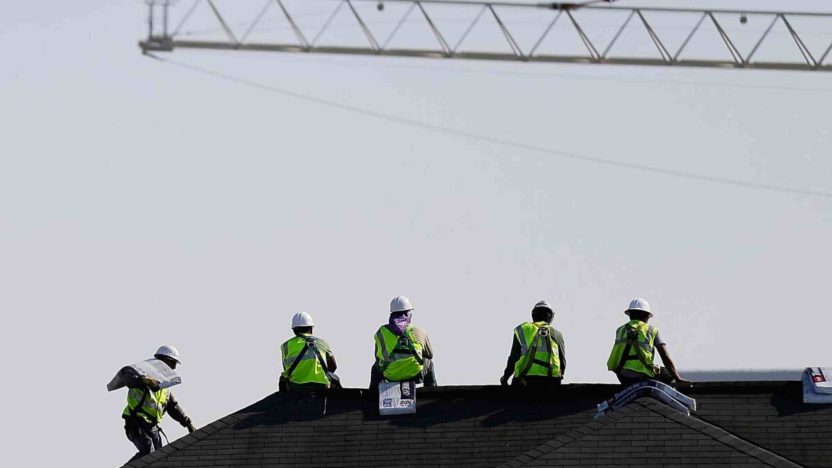 Construction workers on site as White House signals softer U.S. jobs growth
