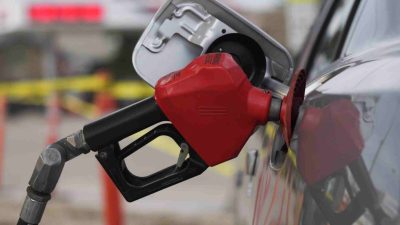 Gas pump nozzle fueling a vehicle amid California wholesale market changes