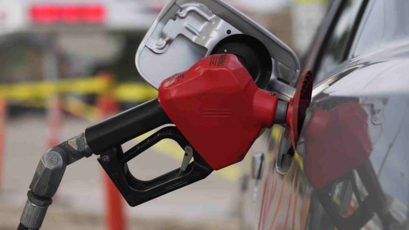 Gas pump nozzle fueling a vehicle amid California wholesale market changes