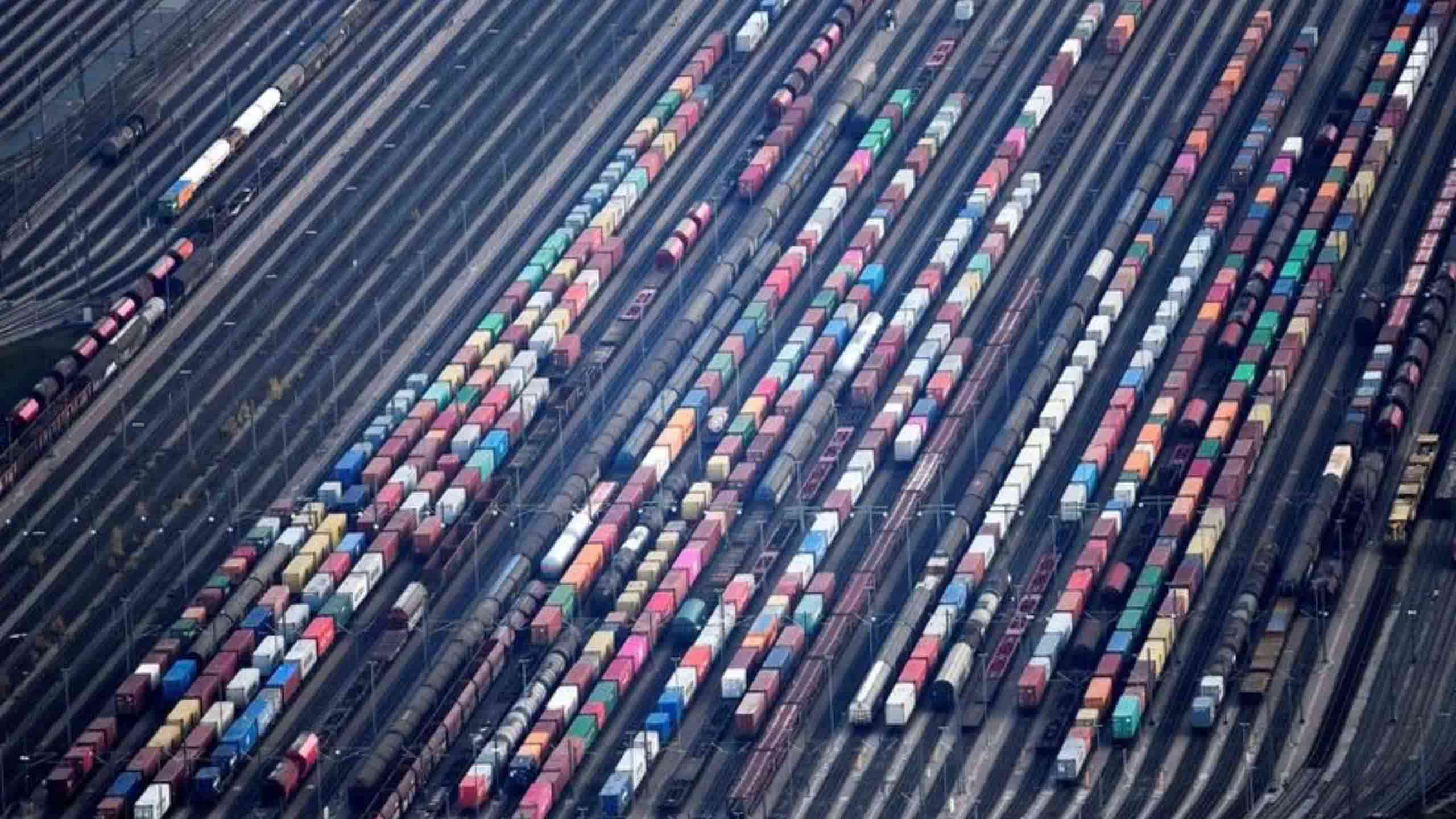 Shipping containers are put onto freight trains at the railway yard in Maschen near Hamburg, Germany
